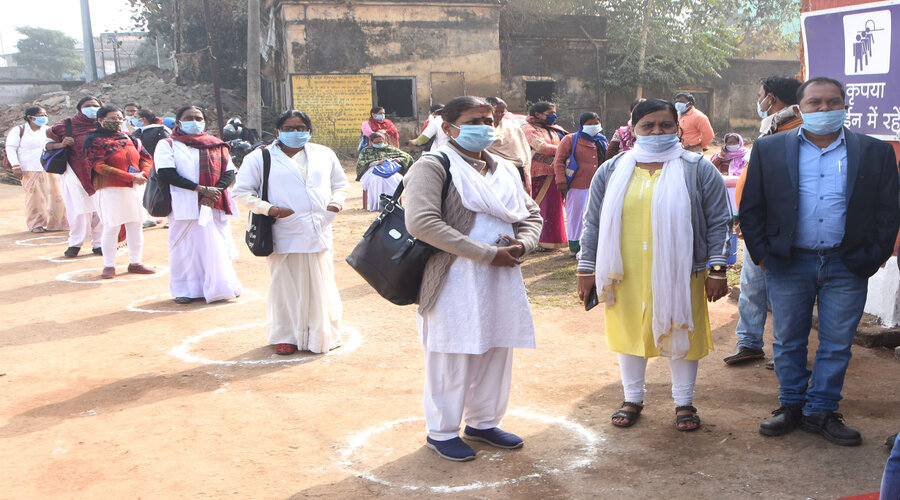 Health workers wait for their turn in vaccination process in Dhanbad.
