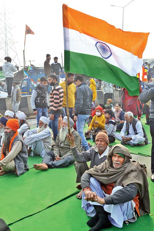 The protesting farmers at the Ghazipur border on Sunday. 