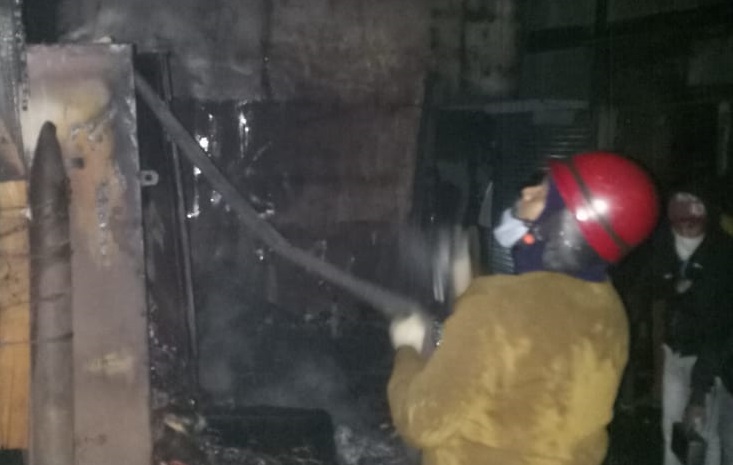 Firemen douse the fire at Sakchi market in Jamshedpur on Sunday night.