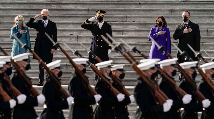 President Joe Biden and Vice President Kamala Harris along with spouses Jill Biden and Doug Emhoff review the troops following the inauguration ceremony