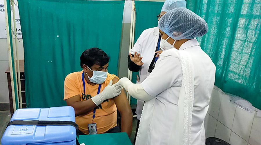 A frontline worker receives his Covishield shot at Sadar Hospital in Ranchi on the first day of the vaccination drive on January 16. 