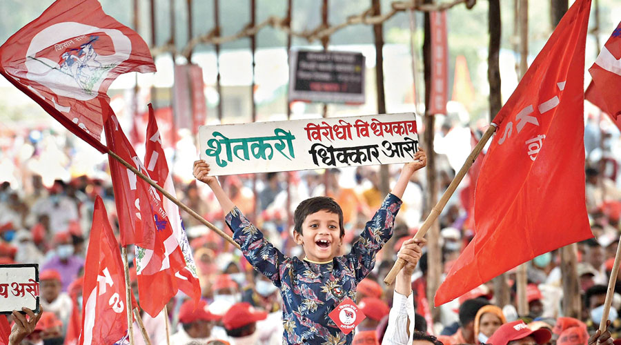 A child at the Azad Maidan rally in Mumbai against the Centre’s three new farm laws holds up a poster that says: “Shame on the anti-farmer laws.” 