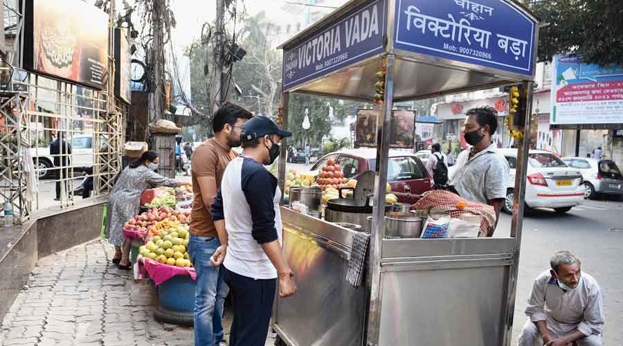 Customers at stalls outside Vardaan Market on Camac Street