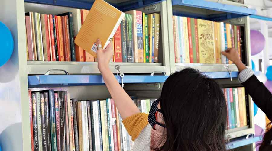 A visitor browses through books at the library