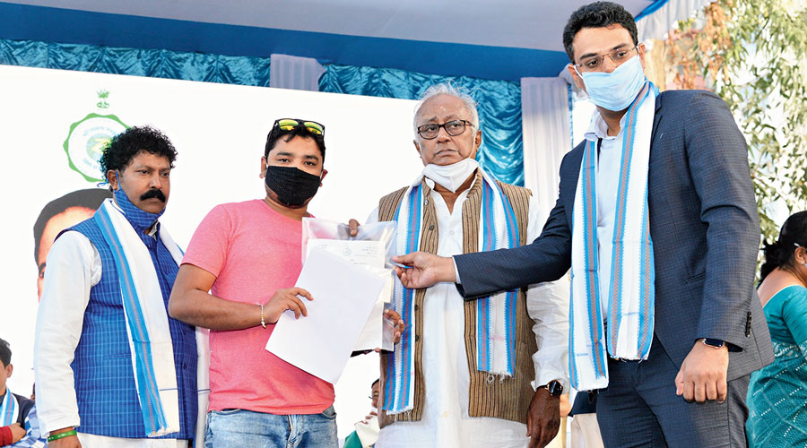 Trinamul MP Sougata Roy hands over the keys to a shopkeeper at Bonorini market.