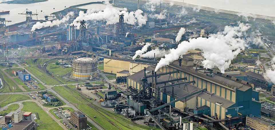 Factory Tata Steel with smoking chimneys on a sunny day, IJmuiden, The  Netherlands Stock Photo