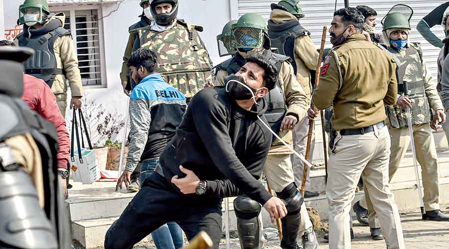 Policemen stand watching  -Groups chanting 'goli maaro…' attack farmers at Singhu border