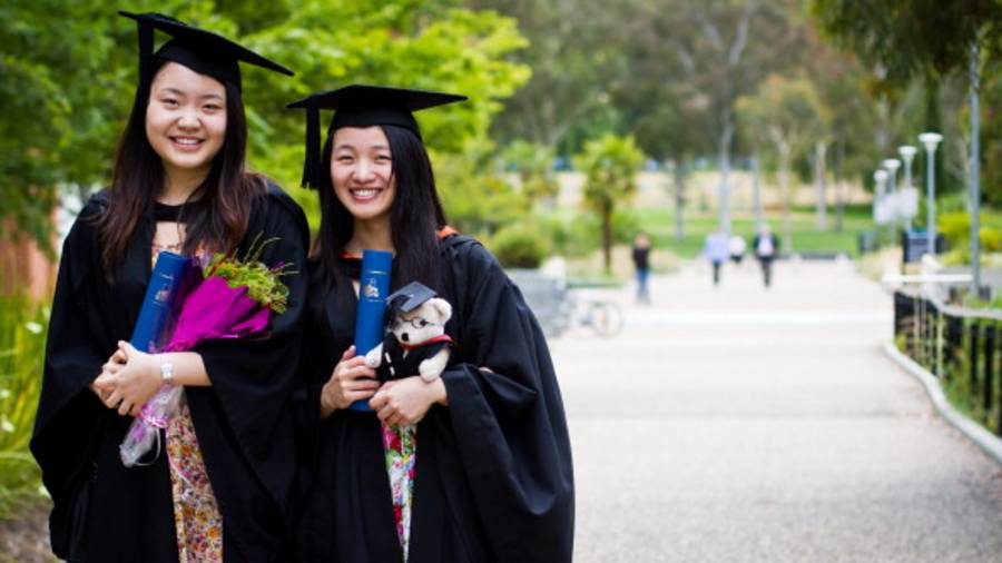 Young Chinese students that have just received their graduation diplomas from the Australian National University in Canberra.