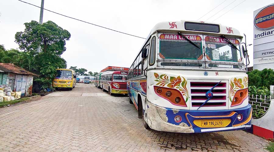Private buses idle at Diamond Harbour. 