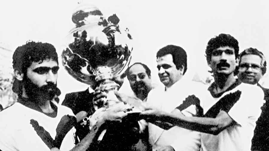 Mohun Bagan’s Achintya Belel and (left) Amit Bhadra receive the Rovers Cup from Dilip Kumar after defeating Mohammedan Sporting in 1991