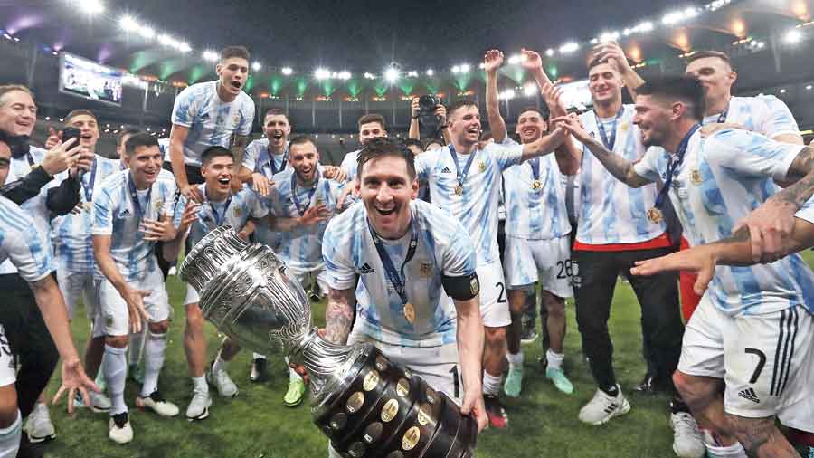 Lionel Messi and teammates celebrate with the trophy after beating Brazil in the final at the Maracana on Saturday