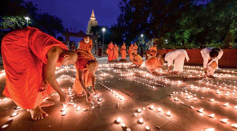 Buddhist monks light candles in Bodh Gaya last month to pray for respite  from the coronavirus.