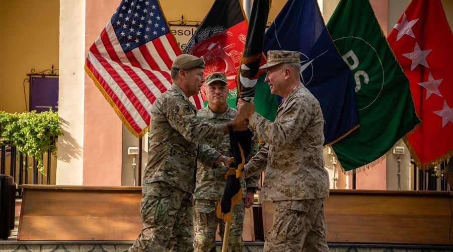 General Austin S. Miller, left, hands over the mission flag to Gen. Kenneth F. McKenzie Jr. during the change of command ceremony in Kabul, Afghanistan on Monday, July 12, 2021. Gen. Miller, the top American general in Afghanistan stepped down on Monday, a symbolic moment as the United States nears the end of its 20-year-old war and Taliban fighters sweep across the country. 