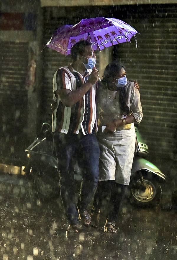 People during heavy rain at Malakpet in Hyderabad on Monday
