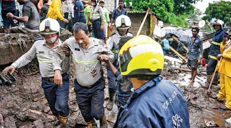 Firemen and rescue workers at the site of a wall collapse in Chembur, Mumbai,  on Sunday