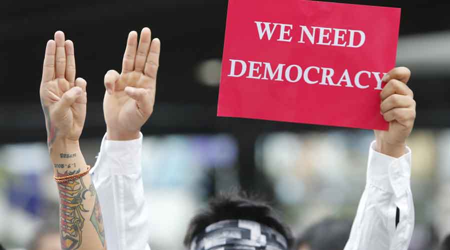 Pro-democracy activists with a placard in Myanmar.
