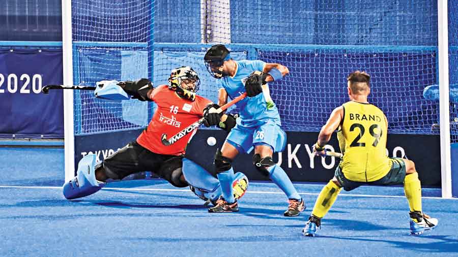 India goalkeeper P. R. Sreejesh attempts unsuccessfully to prevent a goal during a Pool A hockey match against Australia in Tokyo on Sunday. Australia won 7-1. 