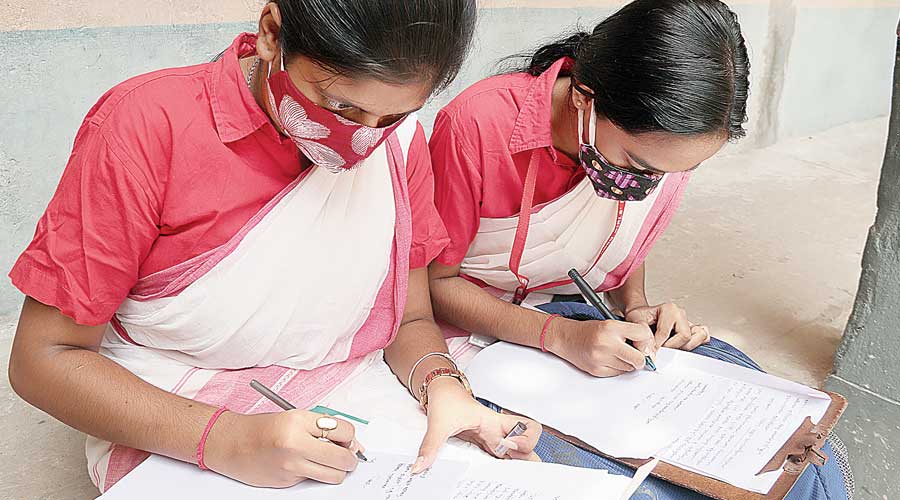 Students submit applications for the review of their marks at a school in Burdwan on Monday. 
