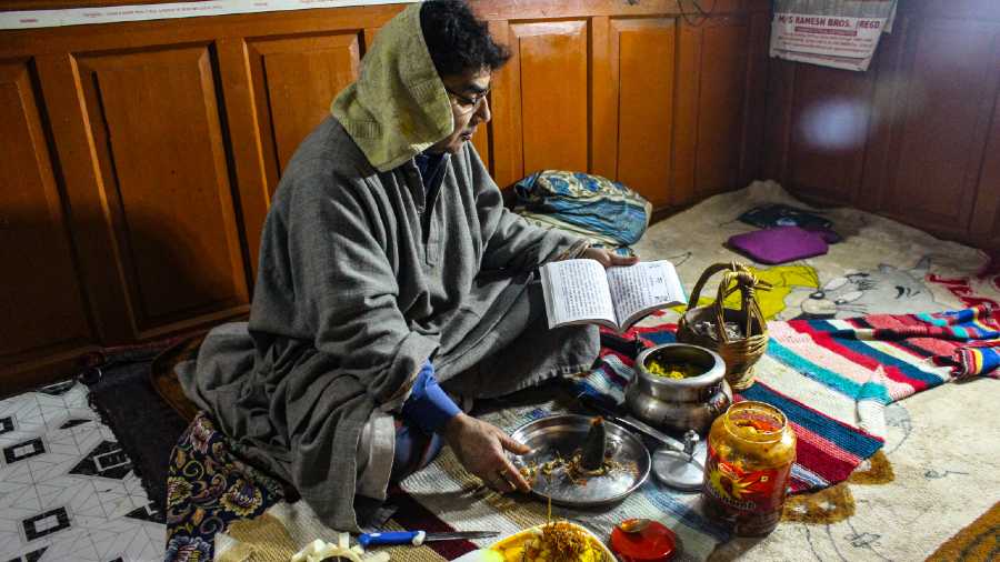 A Kashmiri Pandit doing pooja inside his home.