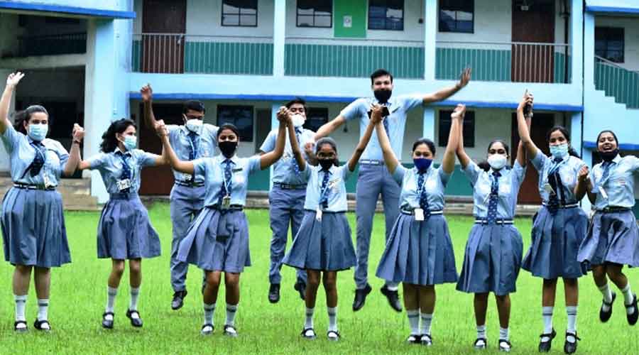 Students celebrate after the CBSE XII results were declared on Friday.