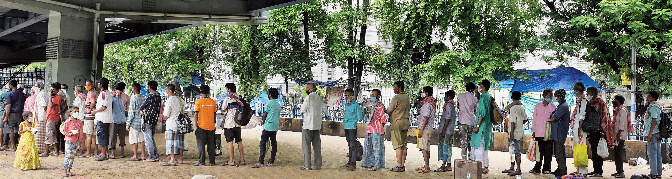 A queue for food under the flyover on Chowringhee Road last week. 