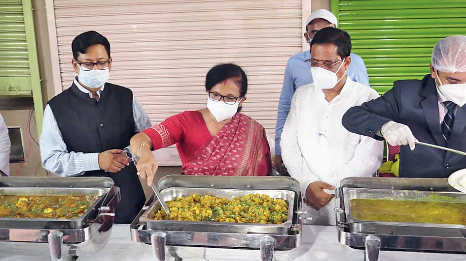 Urban development minister Chandrima Bhattacharya prepares to serve the first customer at Ma Canteen on Tuesday.