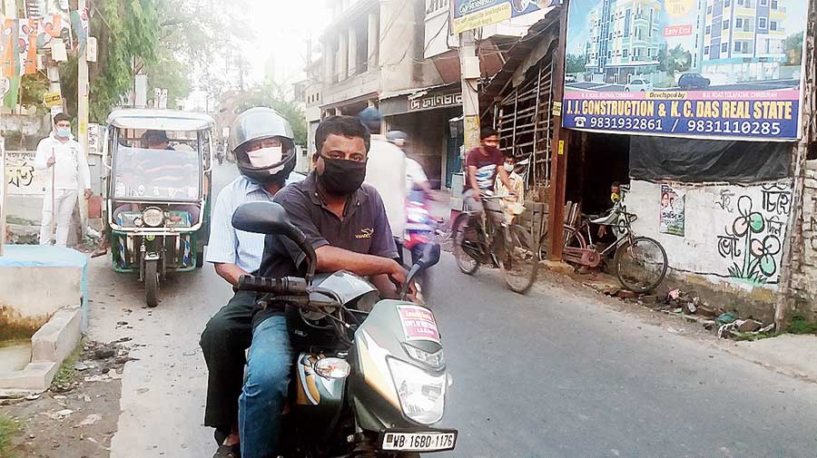 One of the youths ferries a person on his bike in Chinsurah