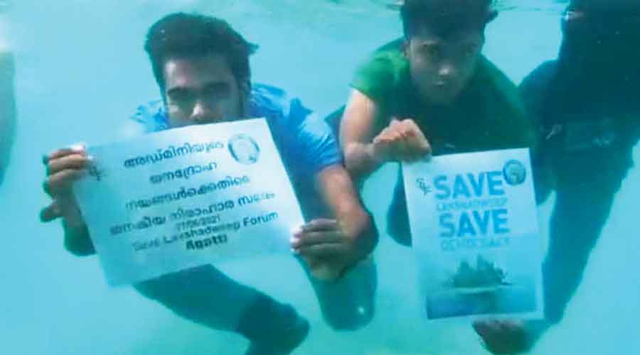 Youths stage an underwater protest on Monday against the controversial decisions of Lakshadweep  administrator Praful Khoda Patel