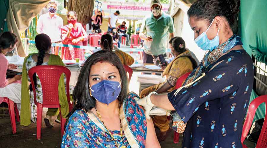 A health worker administers a dose of the Covid-19 vaccine to a woman at a regional hospital in Kullu on Monday.
