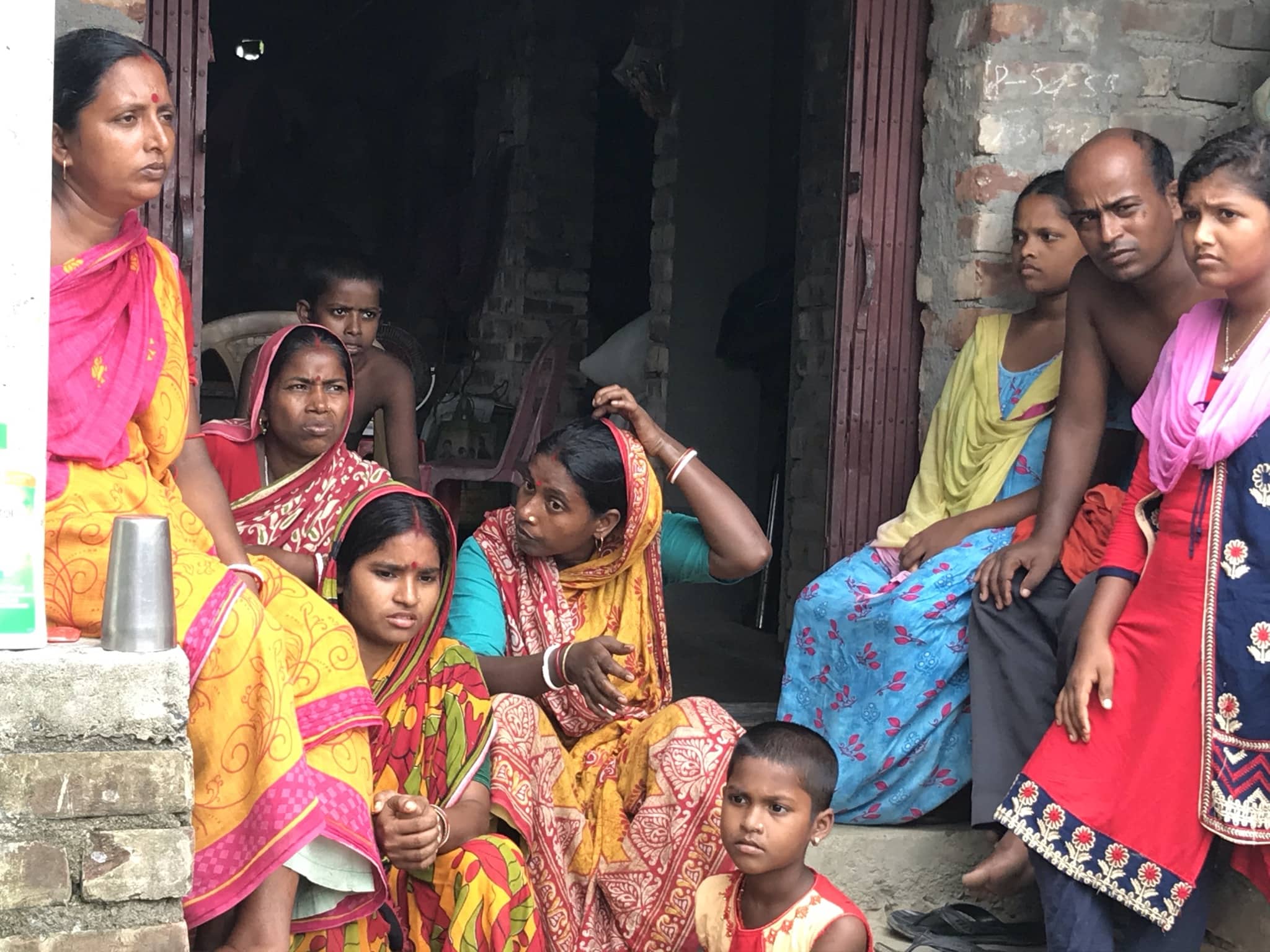 At Maitymore in Kachuberia, the Mandals, including their relatives and near relatives are huddled in their half-built house. Their documents, cattle were scattered as the water level rose on the day of cyclone Yaas. The family is waiting to hear from the panchayat and government officials for the compensation, after having filled up the form for Relief-at-your-doorstep (Duaare Tran).