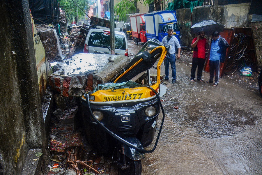 Vehicles damaged after a society compound wall fell on them following heavy rain, at Savarkar Nagar, in Thane on Wednesday.