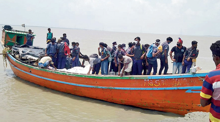 Some residents of the Ghoramara island being shifted by a boat.