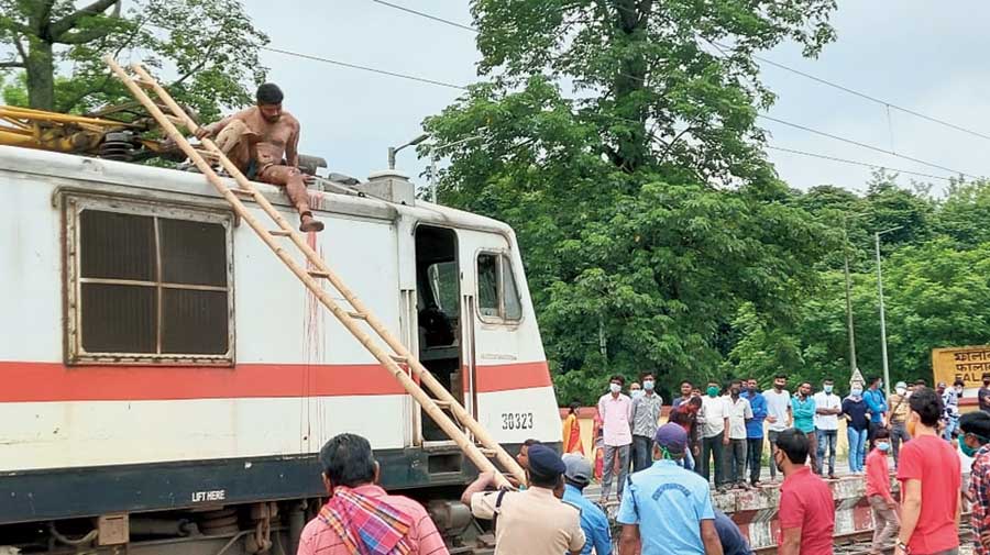 A ladder being used to bring down the youth from the engine at Falakata station on Friday afternoon. 