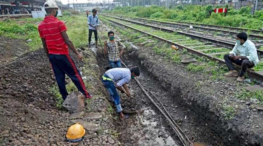 Railway workers undertake track maintenance work near Tatanagar railway station. 