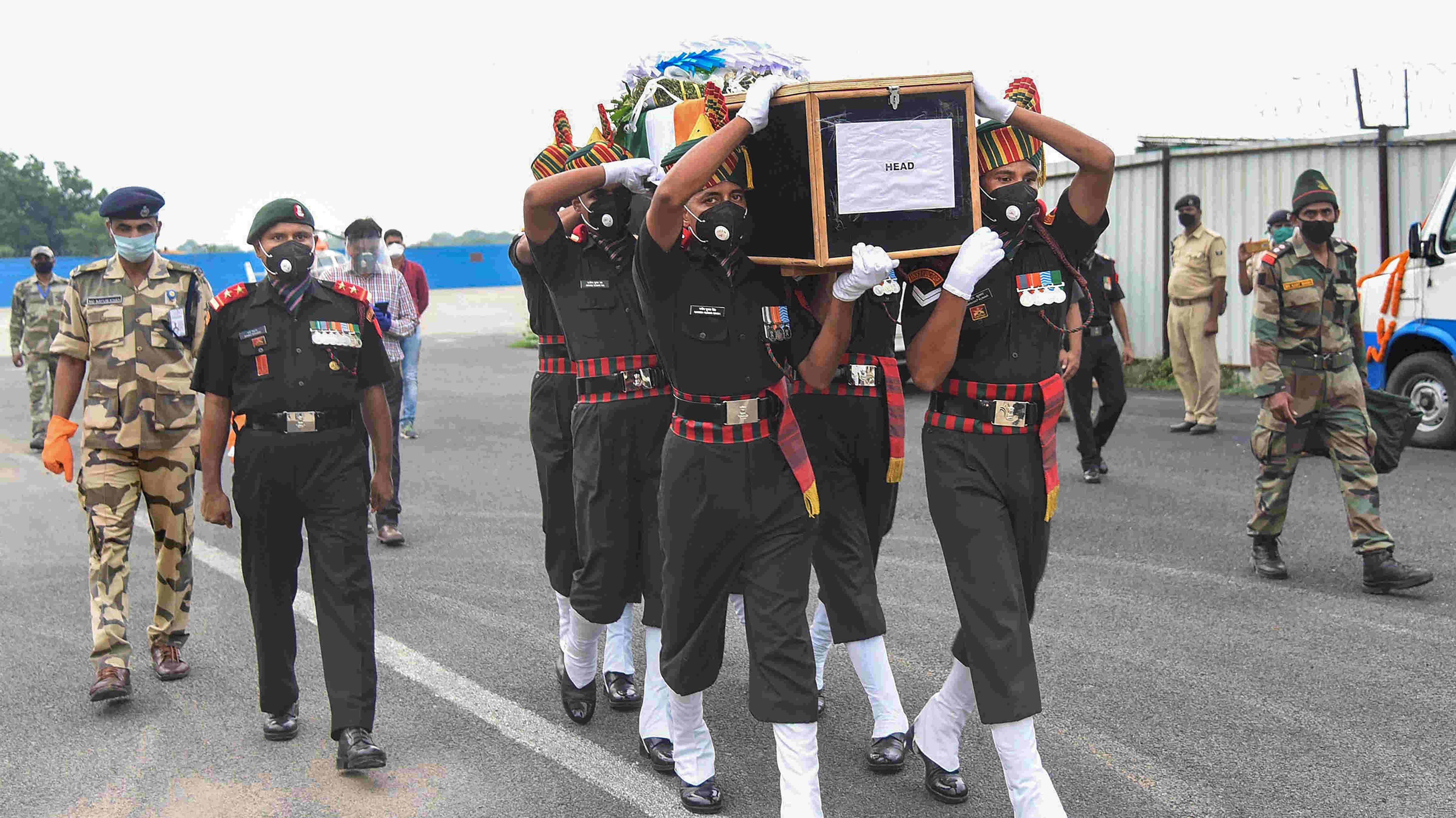 Army personnel carry the casket of Hawaldar Sunil Kumar, who was one of the 20 jawans who were killed during the face-off between Indian and Chinese troops in Ladakh's Galwan Valley, after a wreath-laying ceremony at Jaiprakash Narayan Airport in Patna, Wednesday, June 17, 2020. 