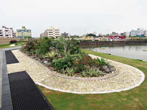 A rock garden surrounded by a pebbled pathway
