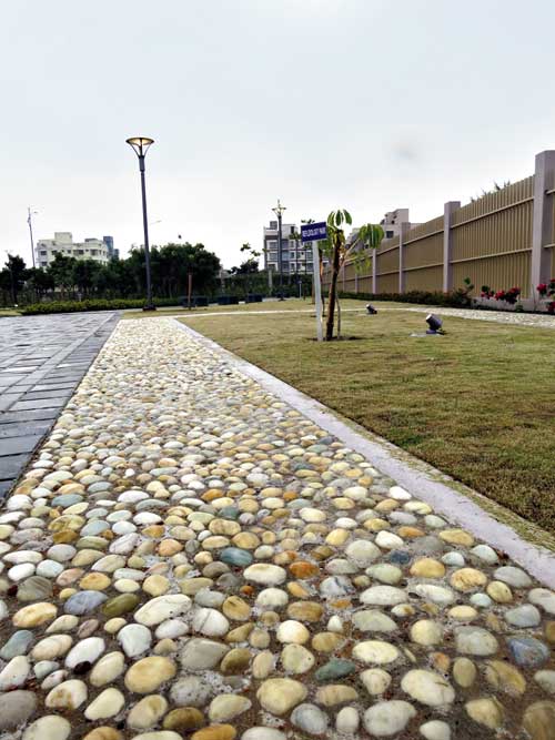 Barefooted walk on the pebbled pathways offers reflexology benefits