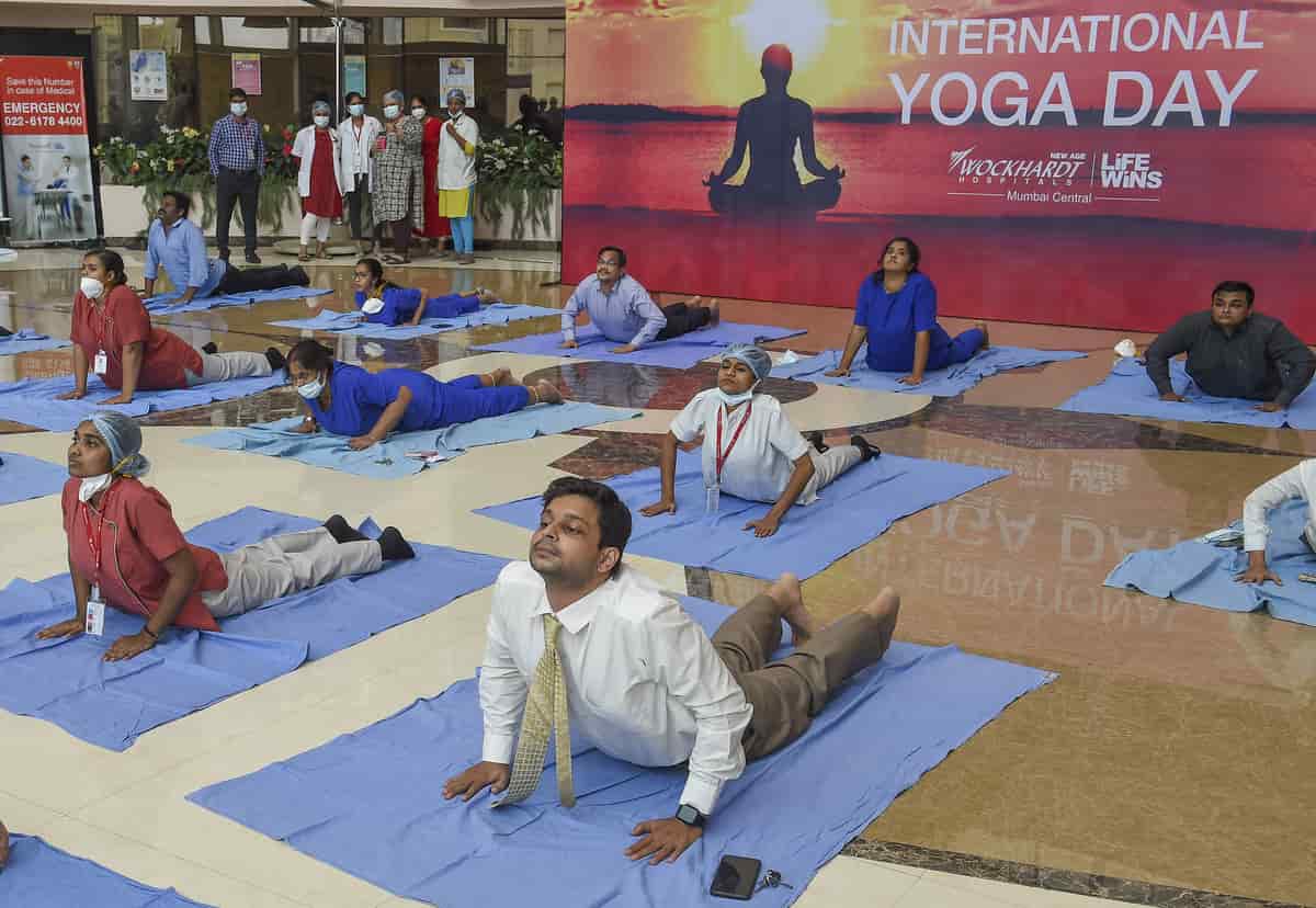 Doctors and other staff attend a Yoga session at a Mumbai hospital on Saturday.