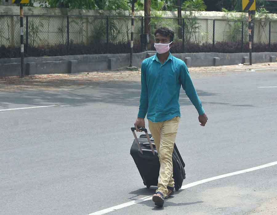 A railway passengers is forced to walk from Dhanbad station on Sunday.