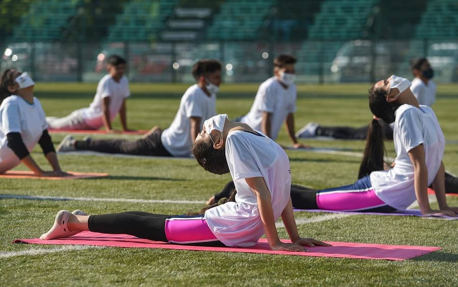 Students perform Yoga on the occasion of International Day of Yoga in Srinagar on Monday