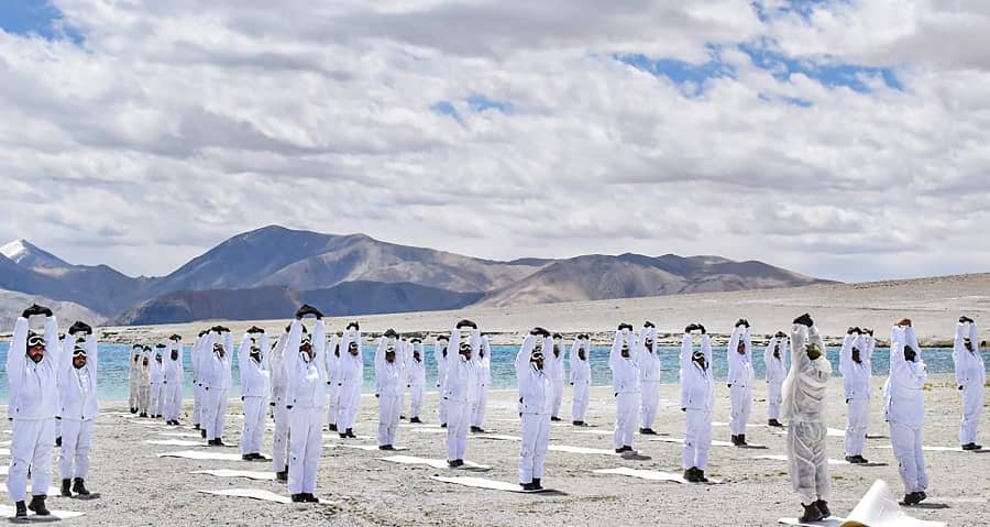 Indo-Tibetan Border Police (ITBP) performs Yoga on International Day of Yoga alongside Pangong Tso lake in Ladakh on Monday.