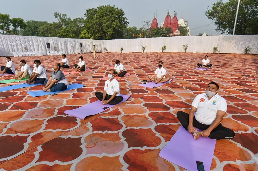 People perform Yoga on International Day of Yoga at Red Fort in New Delhi on Monday.