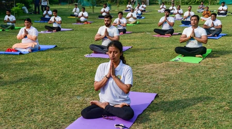 People perform Yoga on International Day of Yoga, in New Delhi.