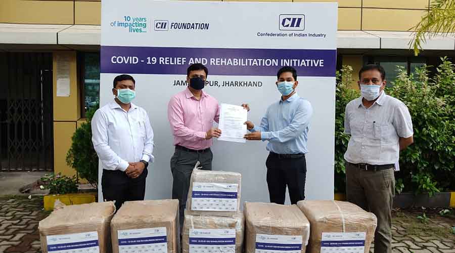 Vijay Bhuller (second from left), state head, CII Jharkhand  hands over the medical equipments to  Suraj Kumar ( second from right),  deputy commissioner of East Singhbhum at the district collectorate in Sakchi on Wednesday. 