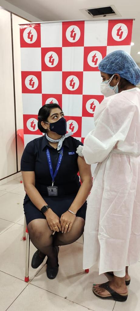 An airline staff receives her vaccine at a drive organised by Techno India Group.