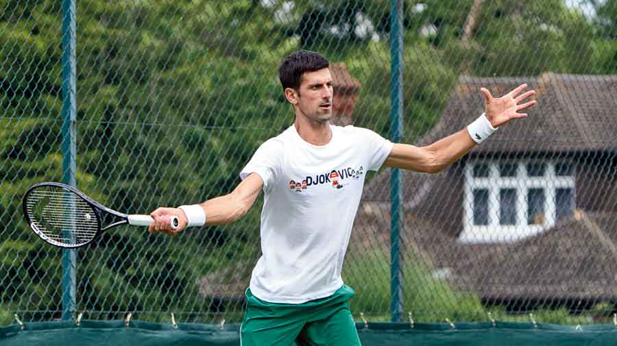 Novak Djokovic gears up at the Aorangi Practice Courts in Wimbledon on Sunday. 