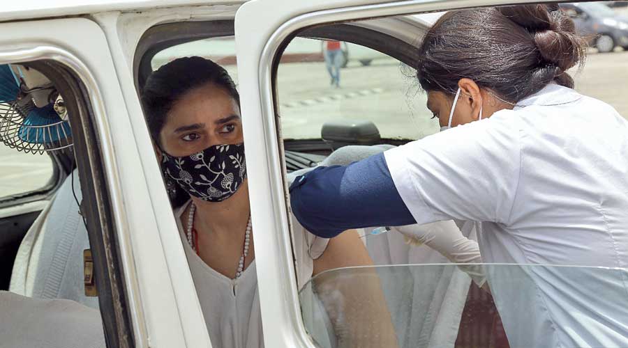 A woman gets vaccinated at Eco Park.