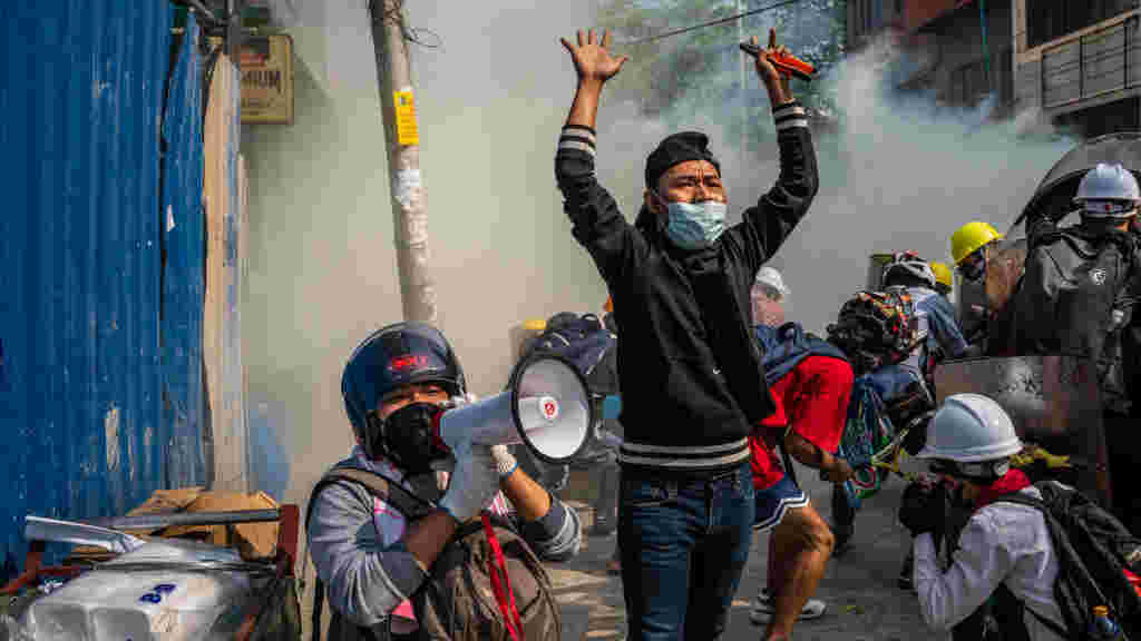 FEBRUARY 28: Protesters ask others to retreat after police fired tear gas on February 28, 2021 in Yangon, Myanmar.