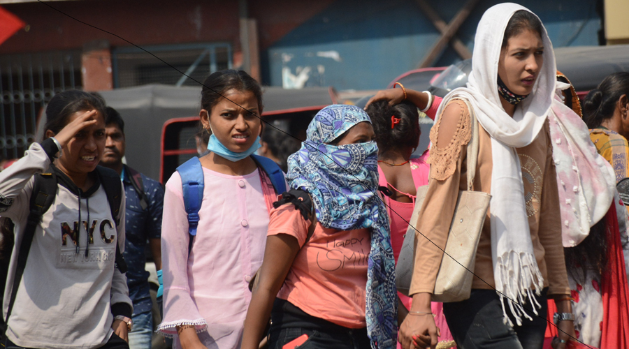 Girls shield their faces from the blistering sun at Sakchi in Jamshedpur on Tuesday.