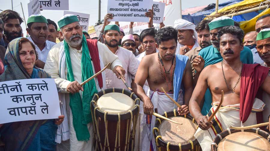Rakesh Tikait plays Chanda Melam with protesters from Kerala during an agitation against new farm laws at the UP Gate in New Delhi on Sunday.